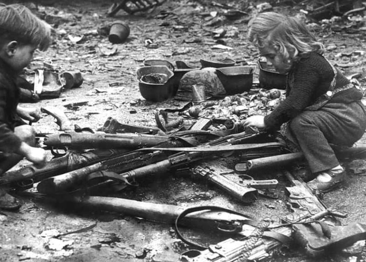 “Children playing with weapons left in the streets of Berlin, 1945.”